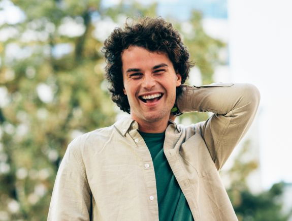 Man grinning outdoors with All-on-X dental implants in Port Chester