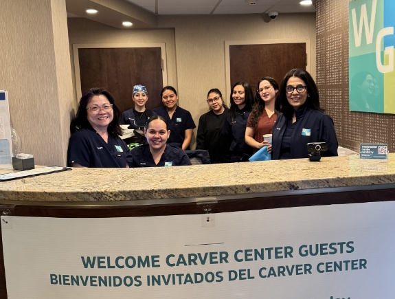 Group of people standing in a circle and placing their hands in the middle