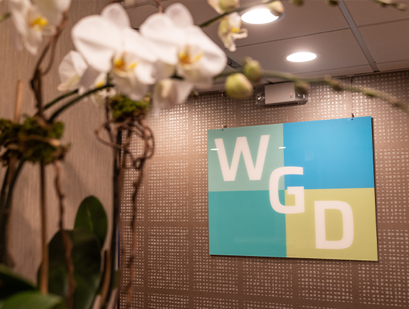 Westchester Gentle Dentistry logo on the wall behind the front desk in Port Chester dental office