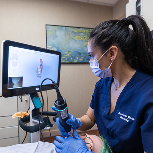 Dentist capturing digital impressions of a patients teeth