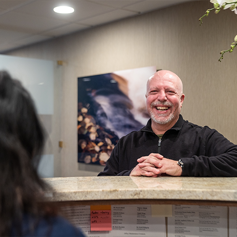 Smiling man checking in at the front desk