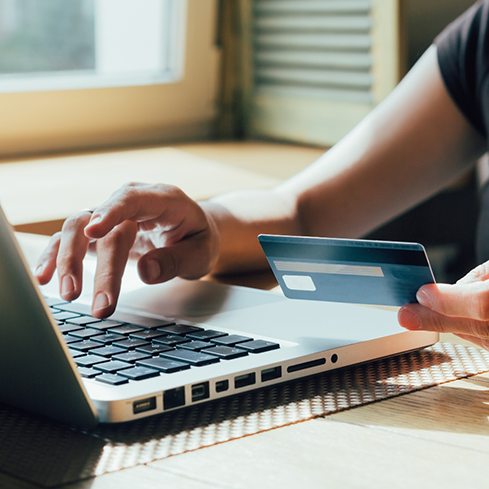 Person entering their credit card information onto their computer