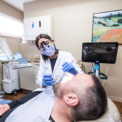 Dentist examining a patients mouth