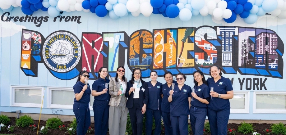Two smiling Port Chester dentists with four team members at Westchester Gentle Dentistry