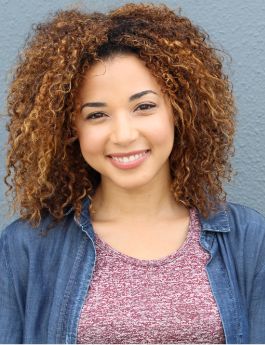 Young woman in a denim shirt smiling