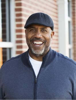 Smiling older man in a black golf cap