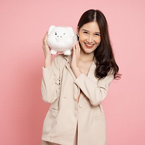 Woman holding a piggy bank and smiling