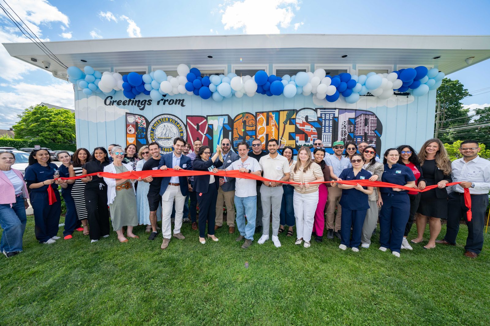 The Westchester Gentle Dentistry team and Port Chester neighbors at the Greetings from Port Chester mural ribbon cutting