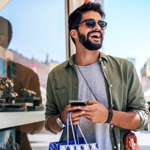 Man smiling while shopping outside