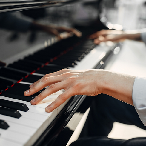 Persons hands playing the piano