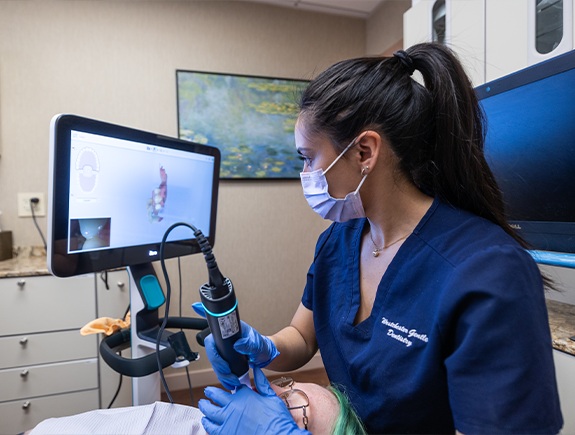 Dentist scanning a patients mouth before replacing missing teeth