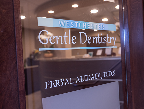 Sign on the outside of a door that reads Westchester Gentle Dentistry Feryal Alidadi D D S