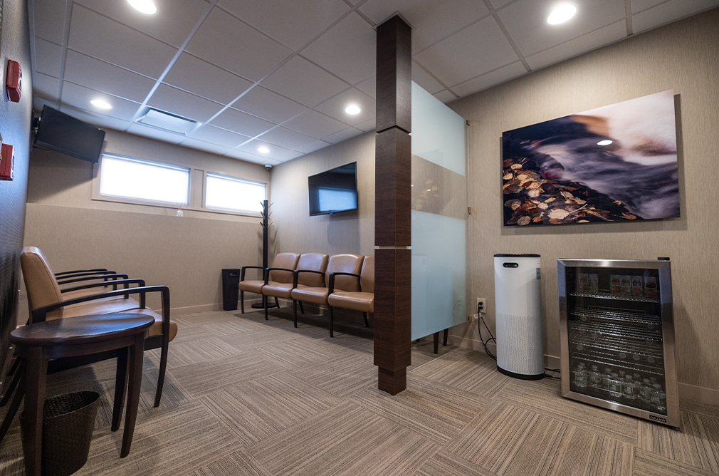 Two rows of brown chairs in waiting area