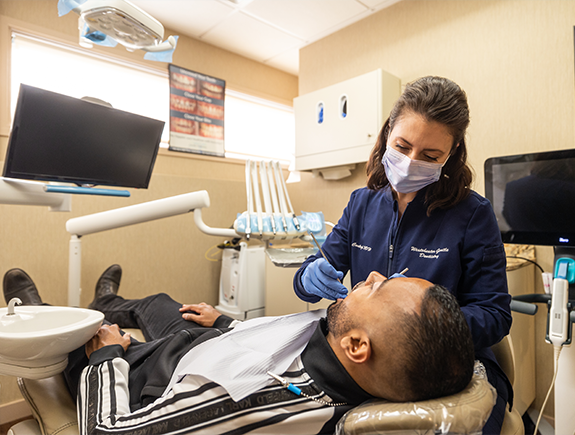 Man receiving a preventive dental checkup from his dentist in Port Chester