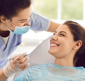 Woman smiling at her dentist during her checkup