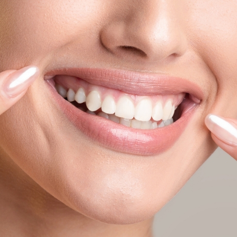 Smiling woman pointing at smile