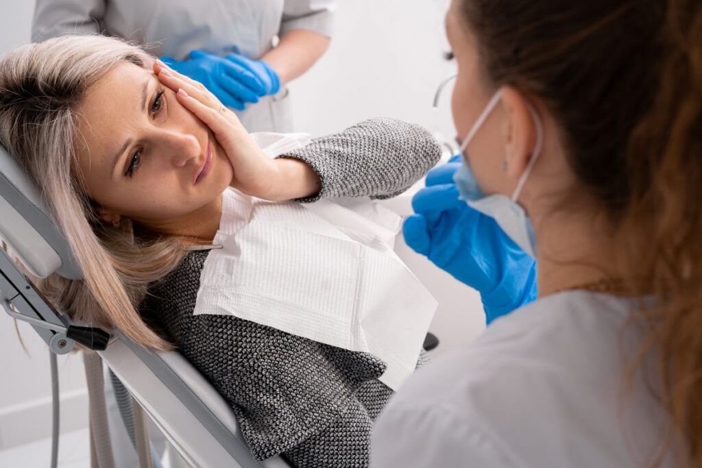 A woman at the dentist with a dental emergency.