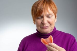 Woman looking at her dentures